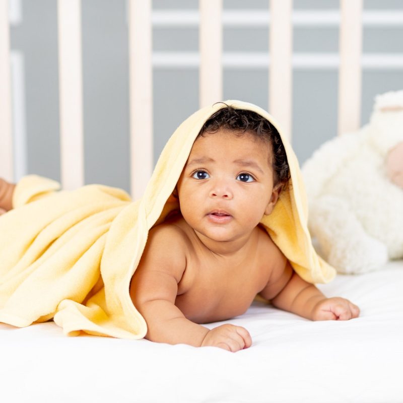 cute-african-american-little-baby-lying-bed-after-bath-yellow-towel